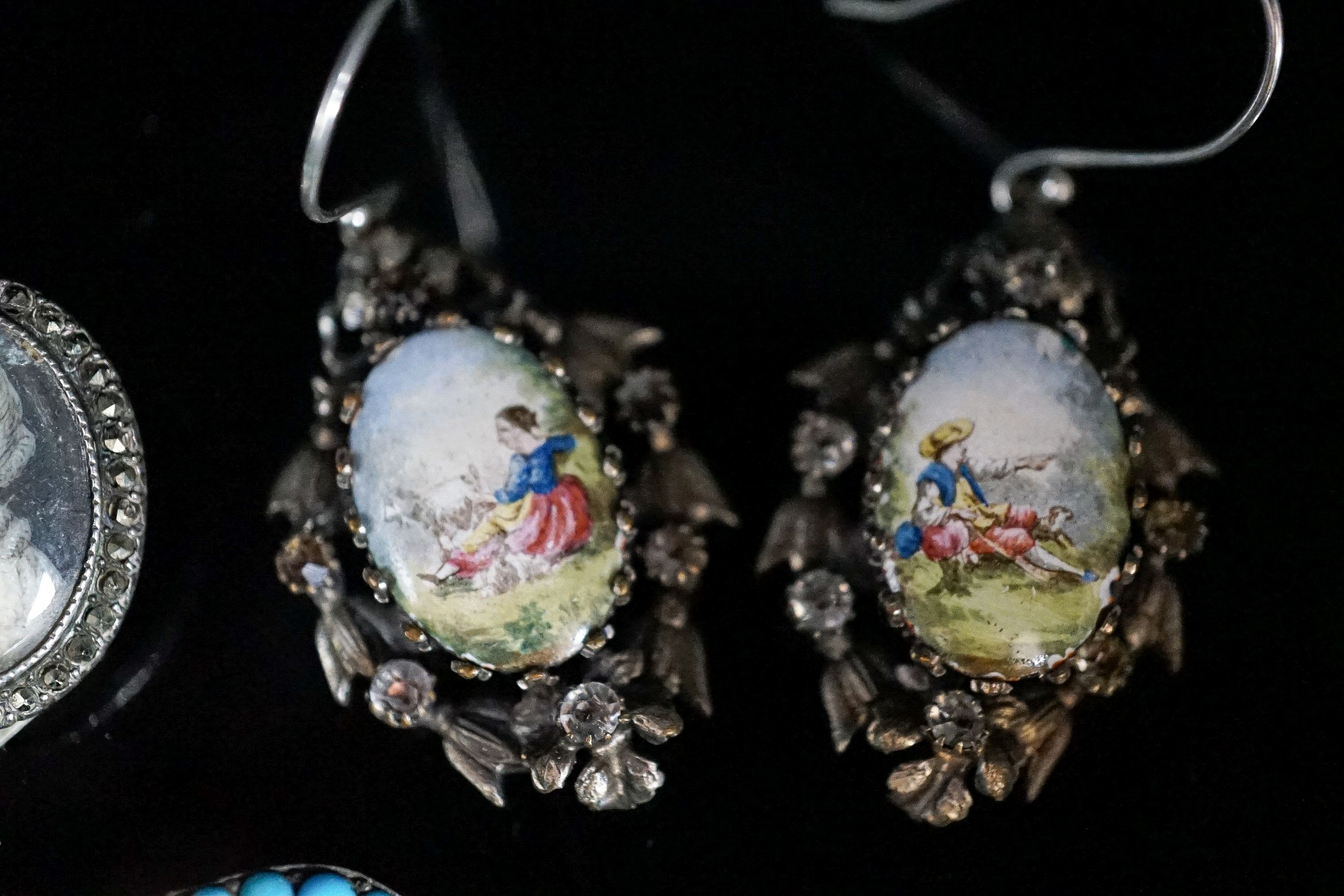 A pair of white metal, enamel and paste earrings, 34mm, a marcasite set double portrait brooch and a turquoise set buckle.